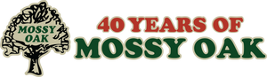 Mossy Oak tree logo and text celebrating 40 years of the brand in red and green lettering on black background